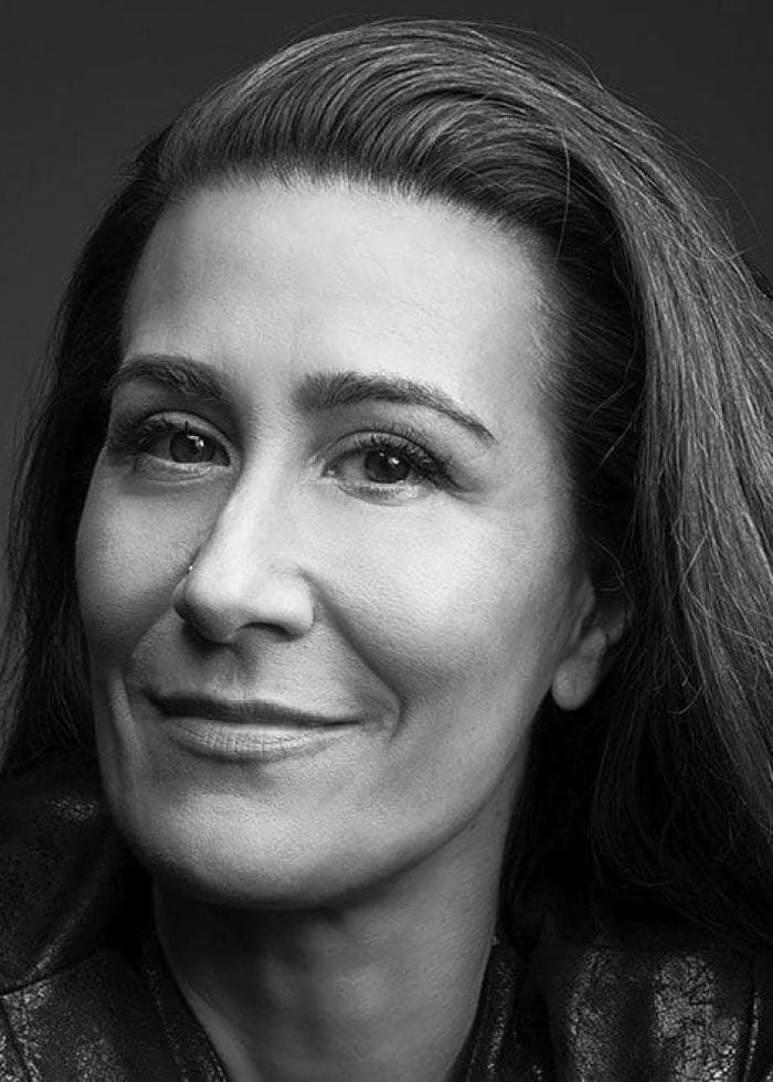Jeanine Tesori, composer and theater artist, smiling in a black and white portrait.