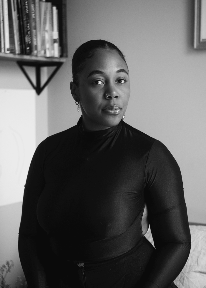 Jerrica D. White in a black turtleneck, looking directly at the camera.