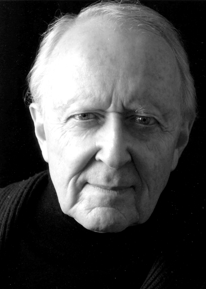 John-Horton John Horton, a man with a serious expression, in a black and white portrait.