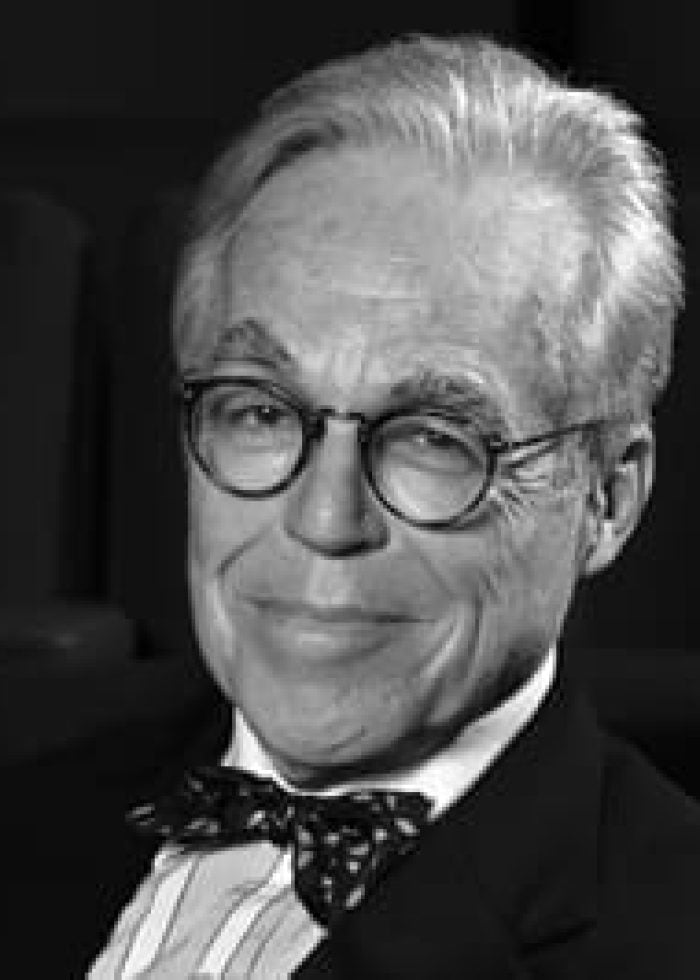 John Guare, playwright, wearing glasses and a bow tie.