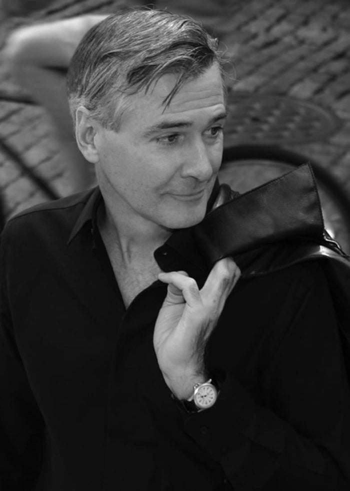 John Patrick Shanley, playwright, looking thoughtful with a leather jacket.