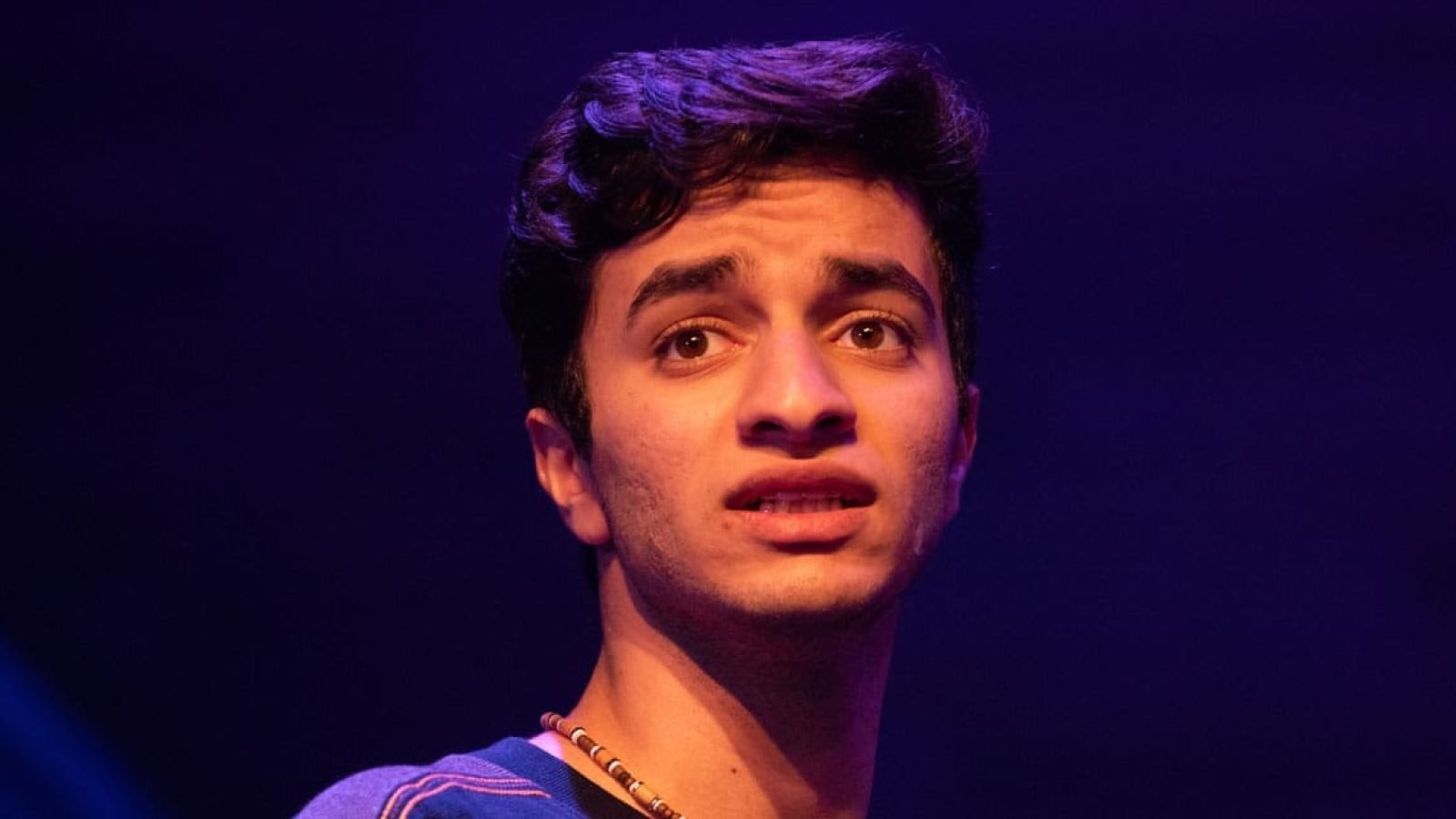 Close-up portrait of a young man with a worried expression.