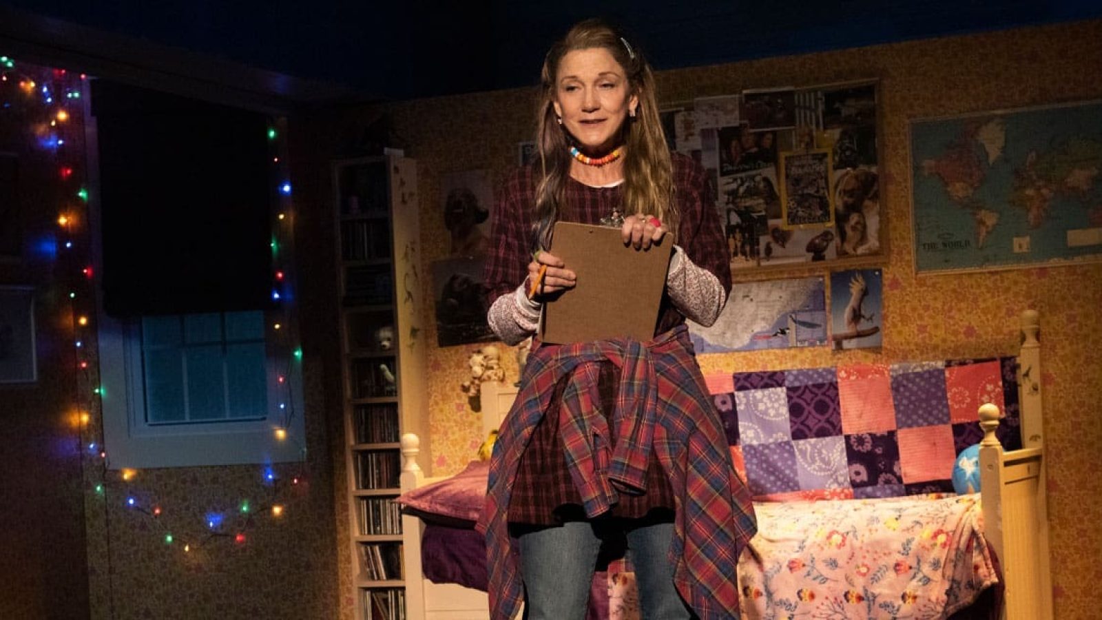 Kimberly Akimbo actress holding clipboard in bedroom set