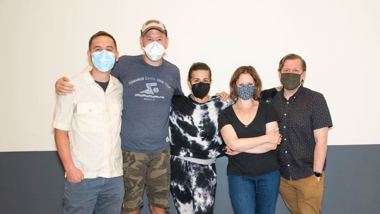The cast of Kimberly Akimbo poses for a photo, wearing face masks.