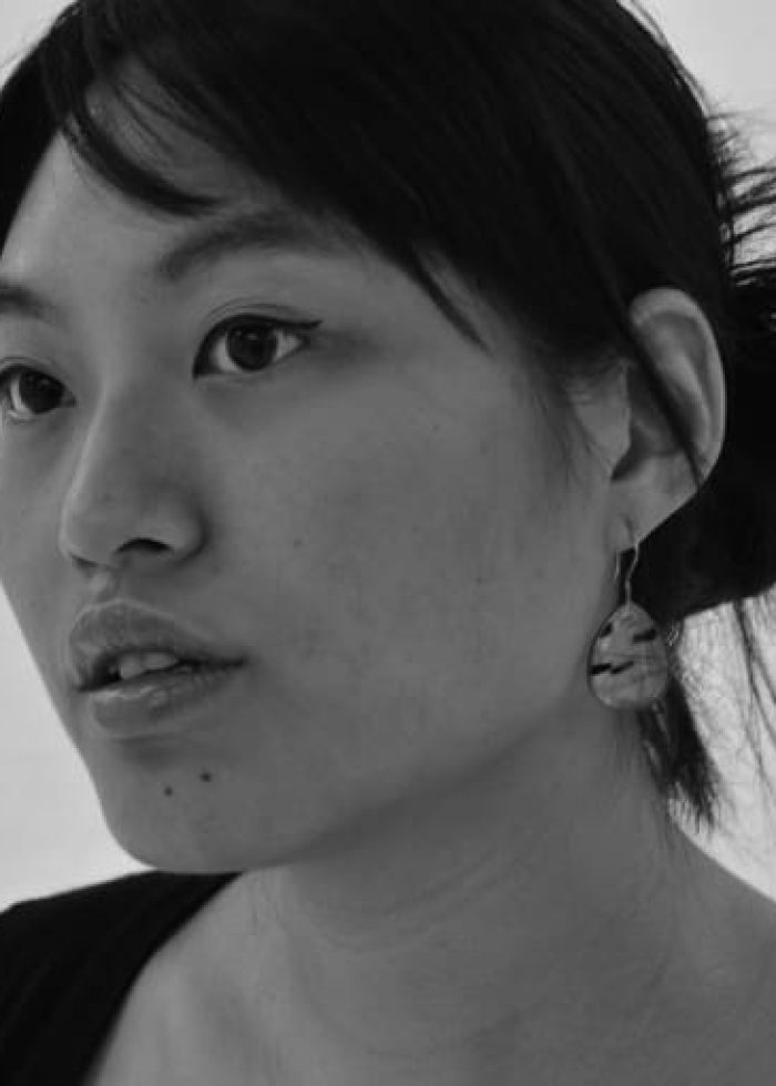 Kat-Yen-BW Black and white portrait of Kat Yen, looking thoughtful with an earring.