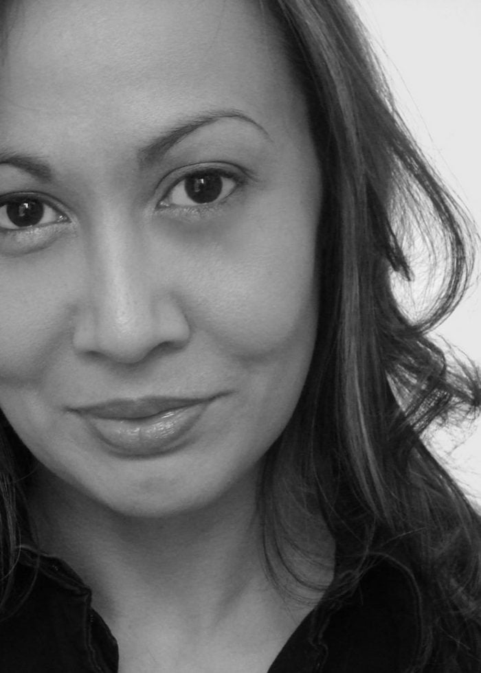 Close-up portrait of Kate Rigg, looking directly at the camera