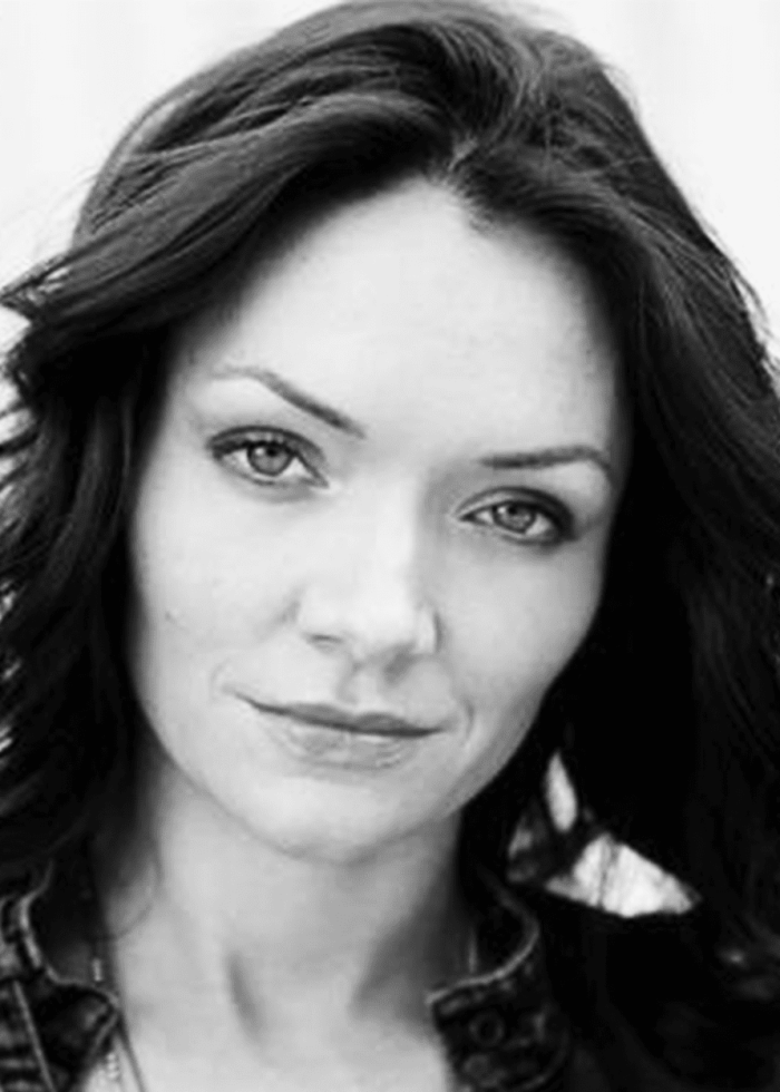 Katrina Lenk poses for a headshot, looking directly at the camera.