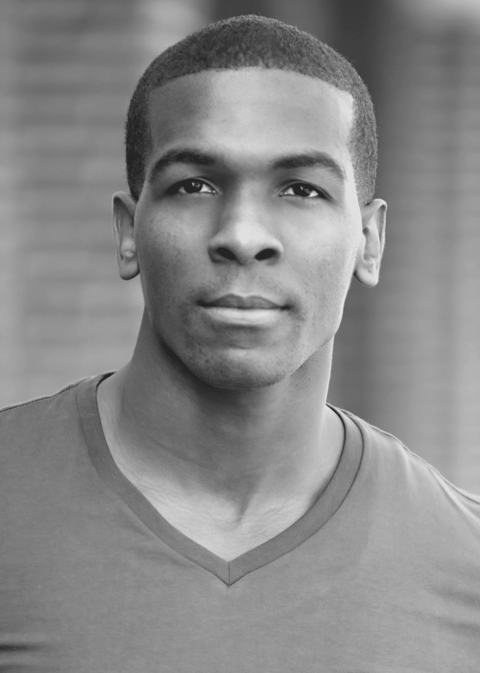 Khris Davis looking directly at the camera in a black and white headshot.