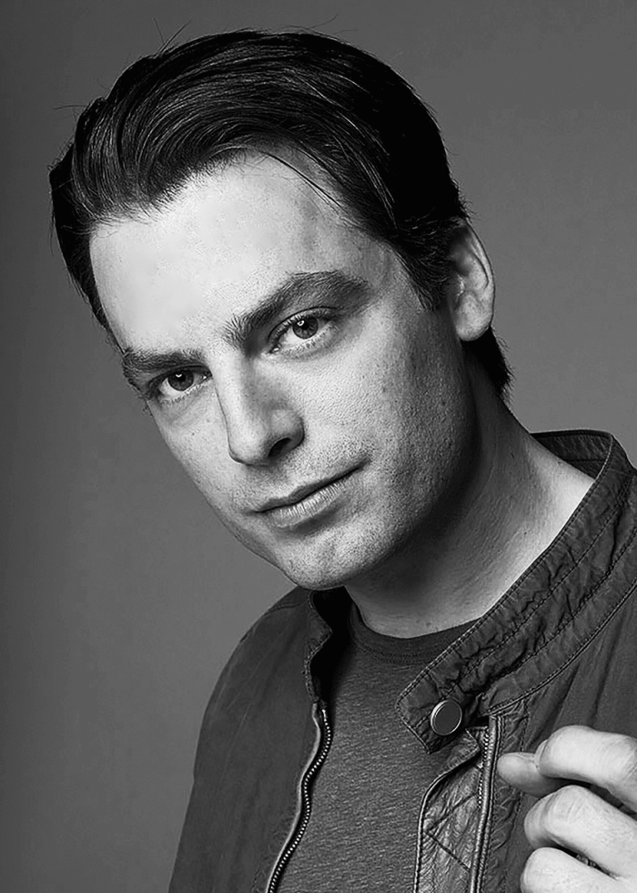 Actor looking at the camera in a black and white headshot
