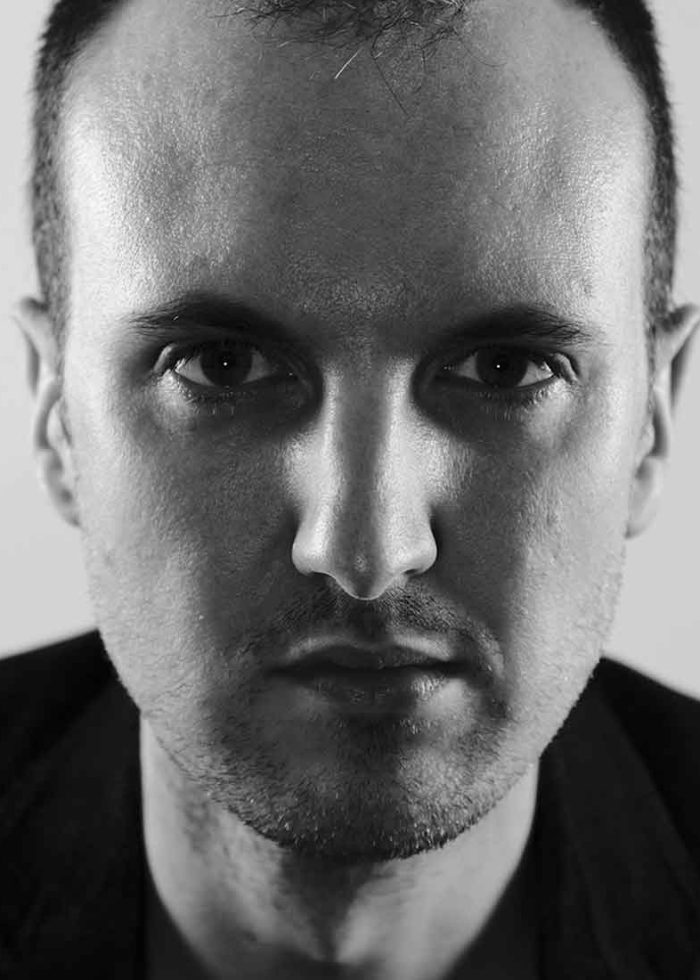 Close-up portrait of Knud Adams, looking directly at the camera