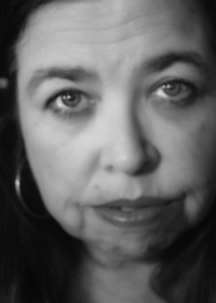 Close-up portrait of Kristina Poe with a thoughtful expression.