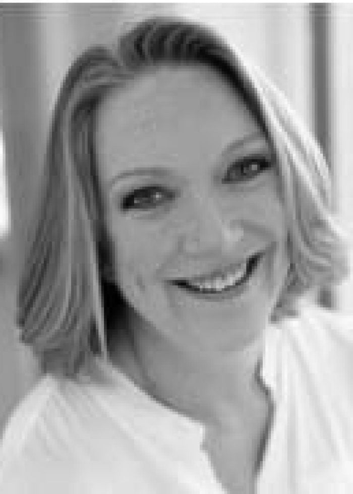 Kristine Nielsen smiling, looking directly at the camera