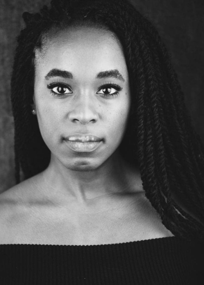 Kristolyn Lloyd portrait in black and white, looking directly at the camera.