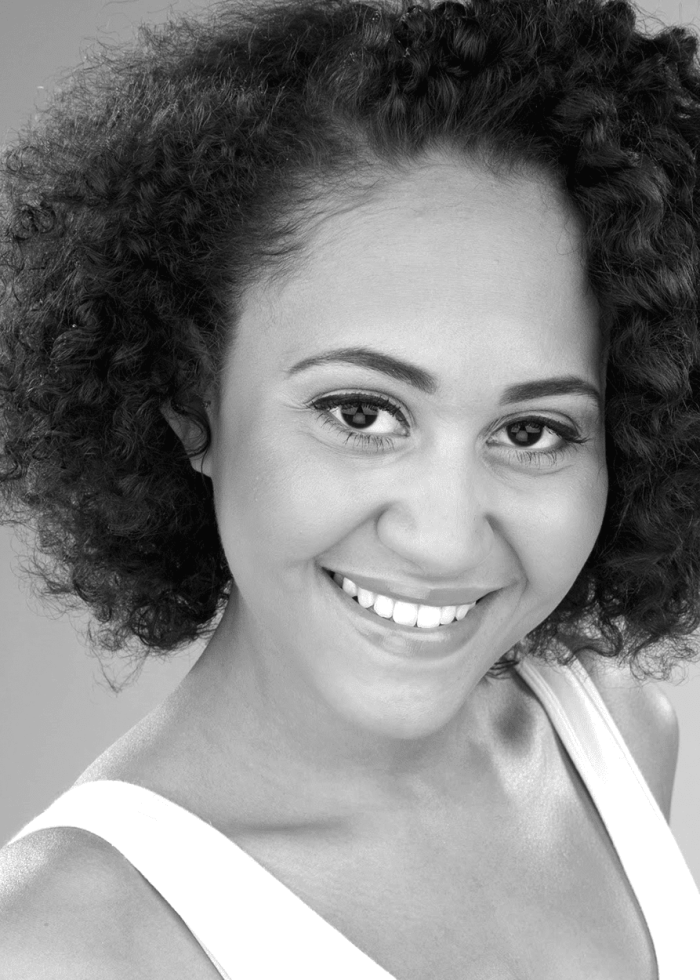 Smiling woman with curly hair in a white tank top