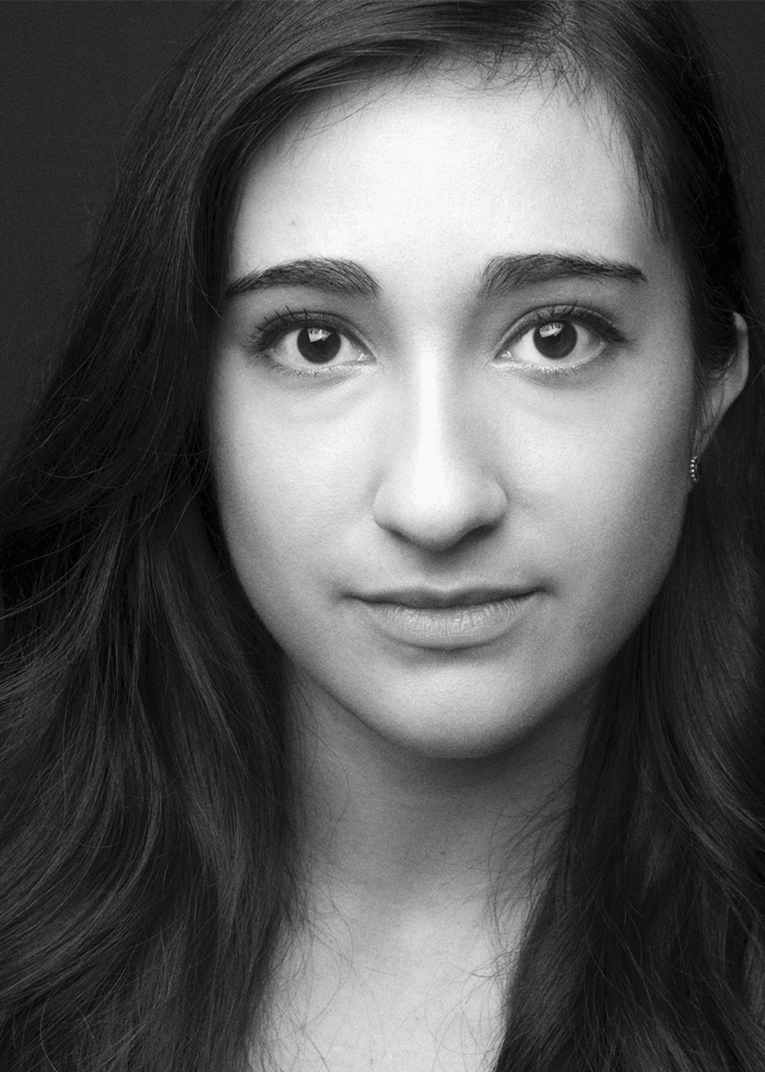 Headshot of Krystina Alabado, looking directly at the camera with a neutral expression.