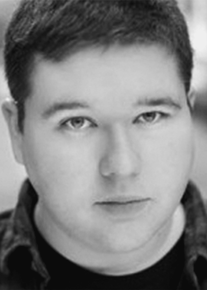 Headshot of Ben Langhorst, looking directly at the camera in black and white.