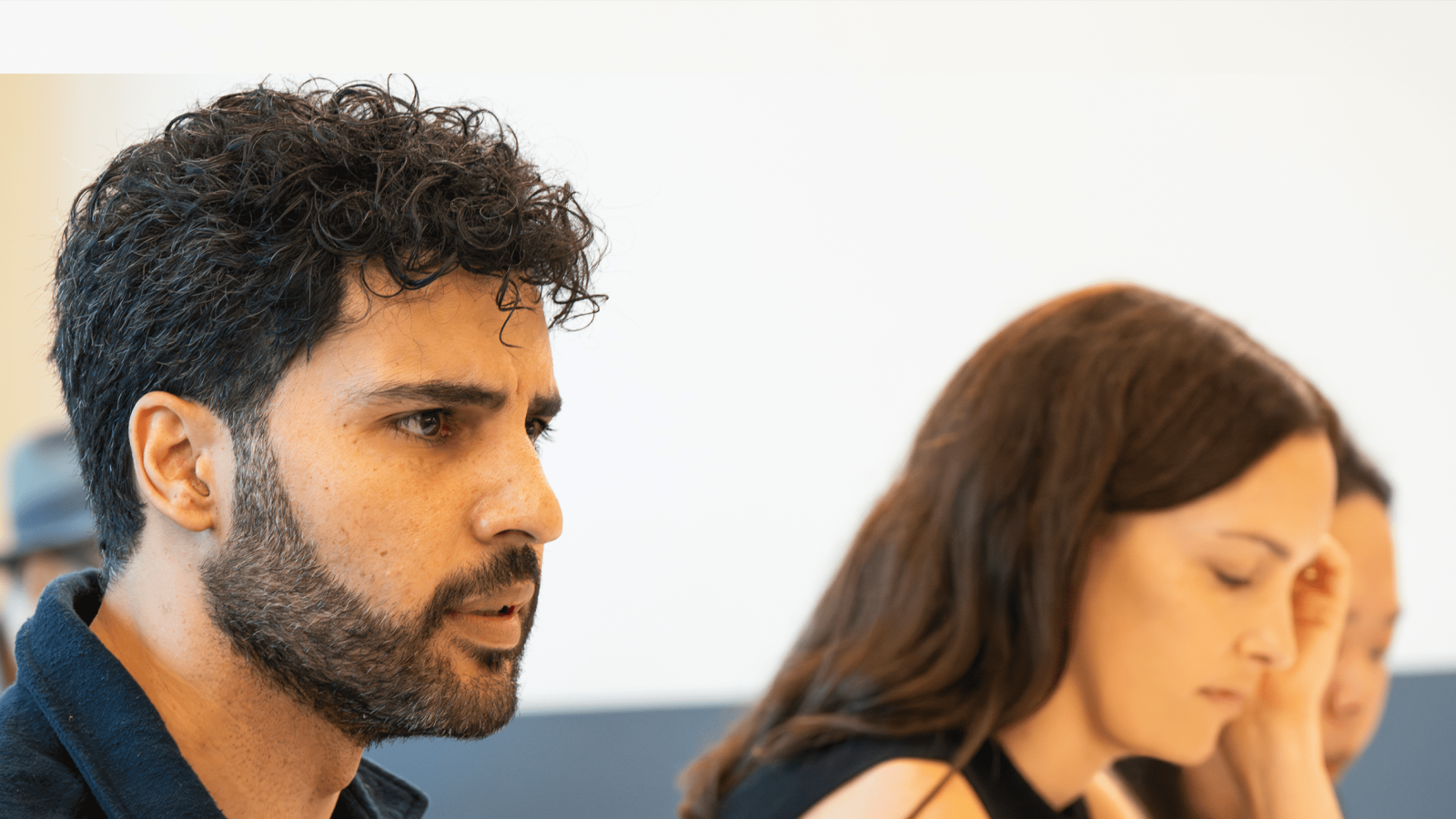 Man and woman in discussion, possibly a business meeting.