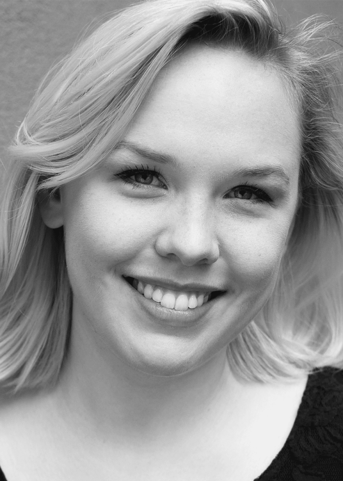 Smiling blonde woman with short hair, looking at the camera.