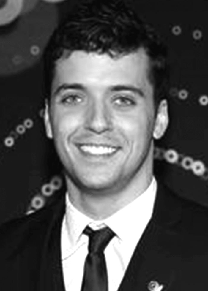 Smiling man in a suit, possibly Marshall Pailet