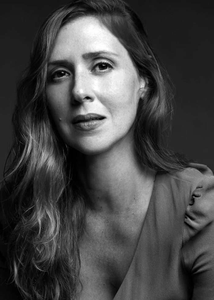 Black and white portrait of Miriam Silverman, looking directly at the camera.
