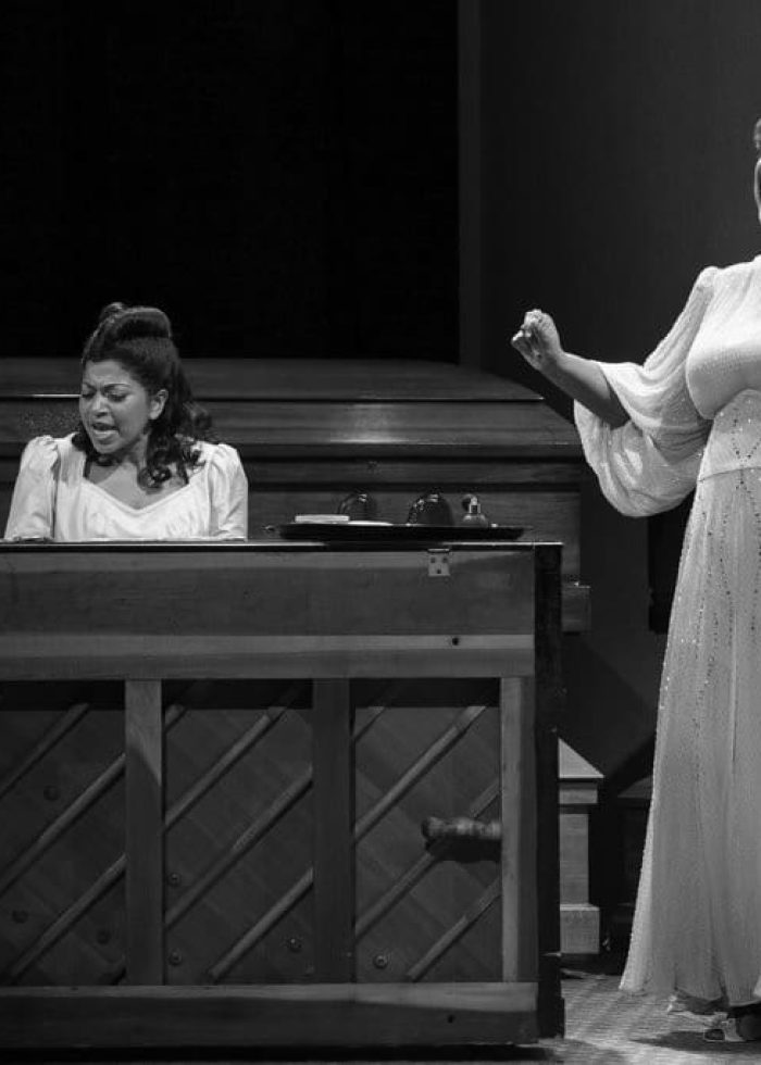 Two women performing in "Marie and Rosetta," one singing powerfully, the other playing piano.