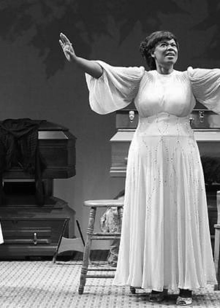 Two gospel singers in a theatrical performance of Marie and Rosetta, arms raised in song.