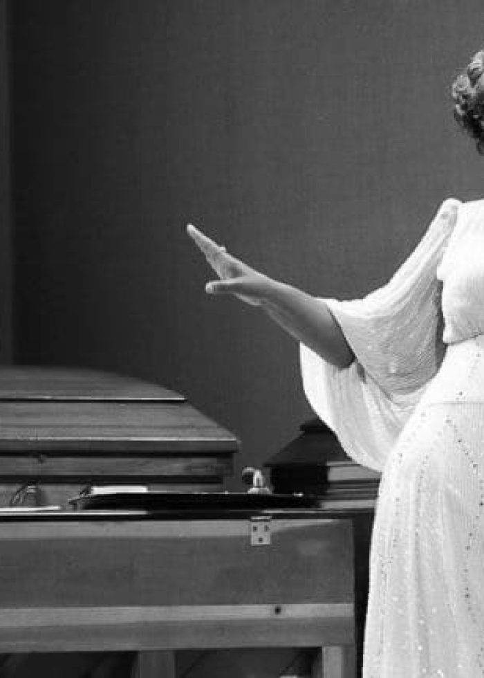 Actresses performing in 'Marie and Rosetta' musical. Singer in white gown, pianist at piano.