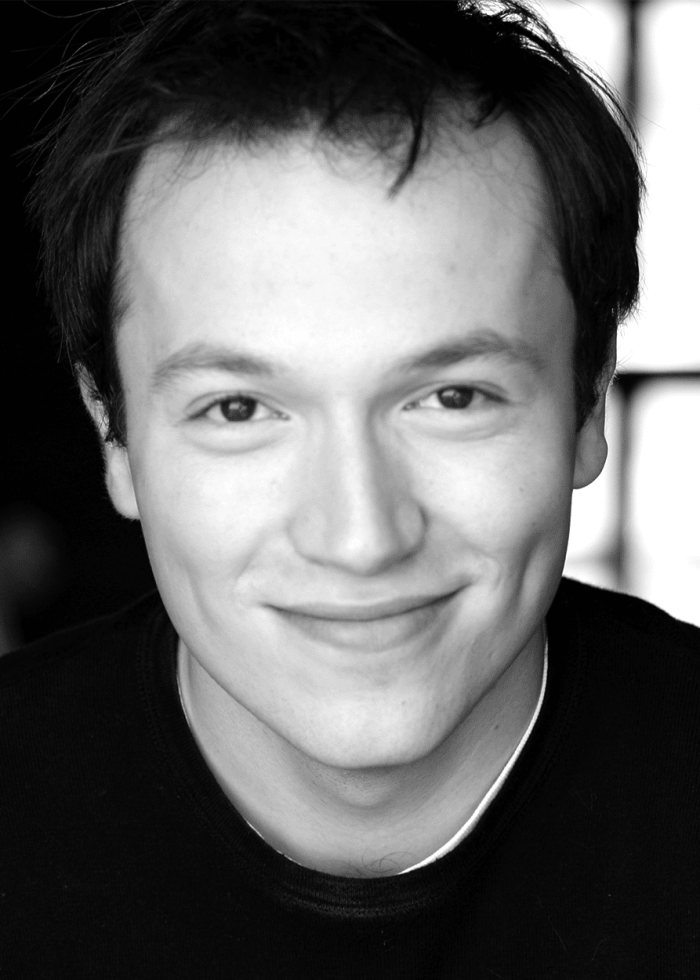 Michael Mahler smiling in a black and white headshot