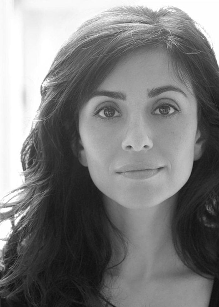 Marjan Neshat, headshot in black and white, looking directly at the camera.
