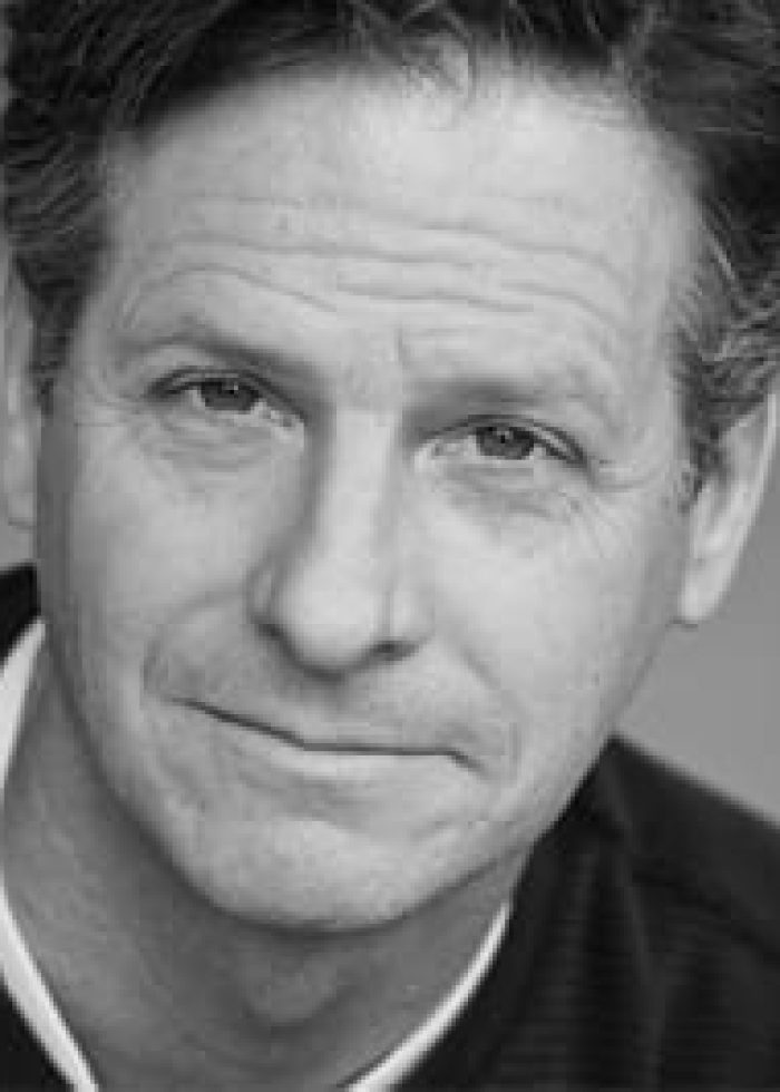 Headshot of a man with a serious expression.