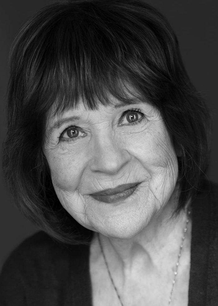 Marylouise Burke, smiling and looking directly at the camera.