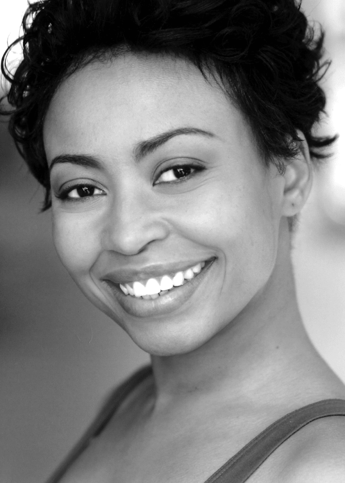 Nikiya Mathis smiles in a close-up, black and white headshot
