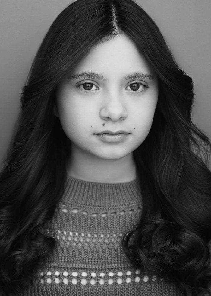 Young girl with long dark hair, portrait view.