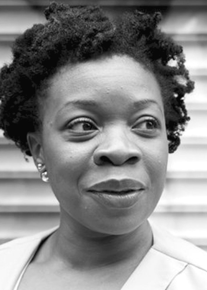 Portrait of Mfoniso Udofia, looking to the side with a slight smile.