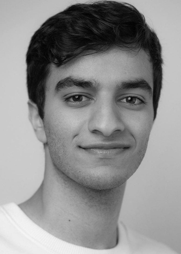 Portrait of Michael Iskander smiling, looking directly at the camera