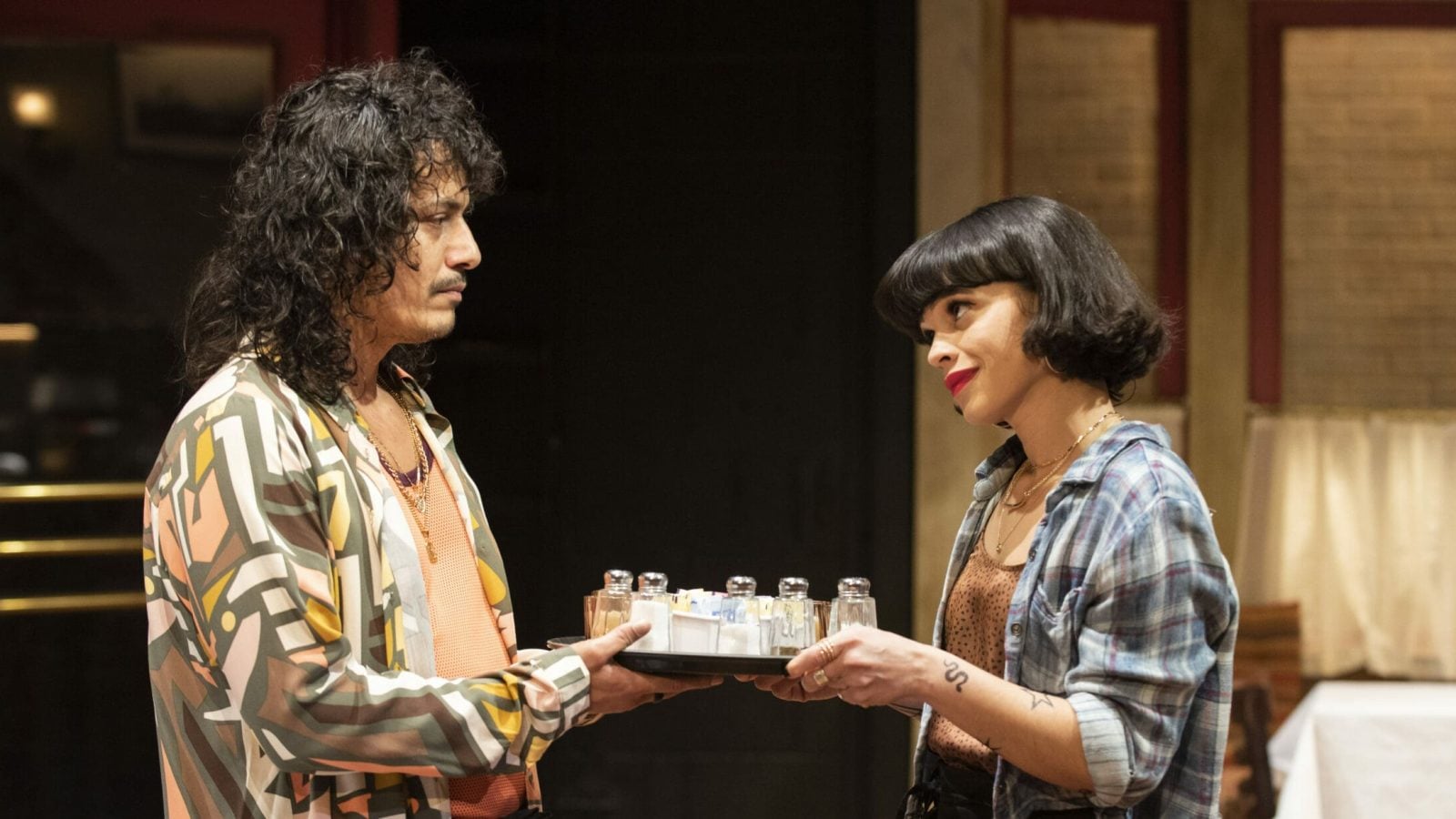 Two actors share a tray of condiments in a scene from *Cornelia Street*.