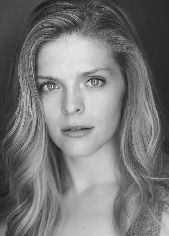 Molly Griggs, actress, headshot in black and white with wavy blonde hair.