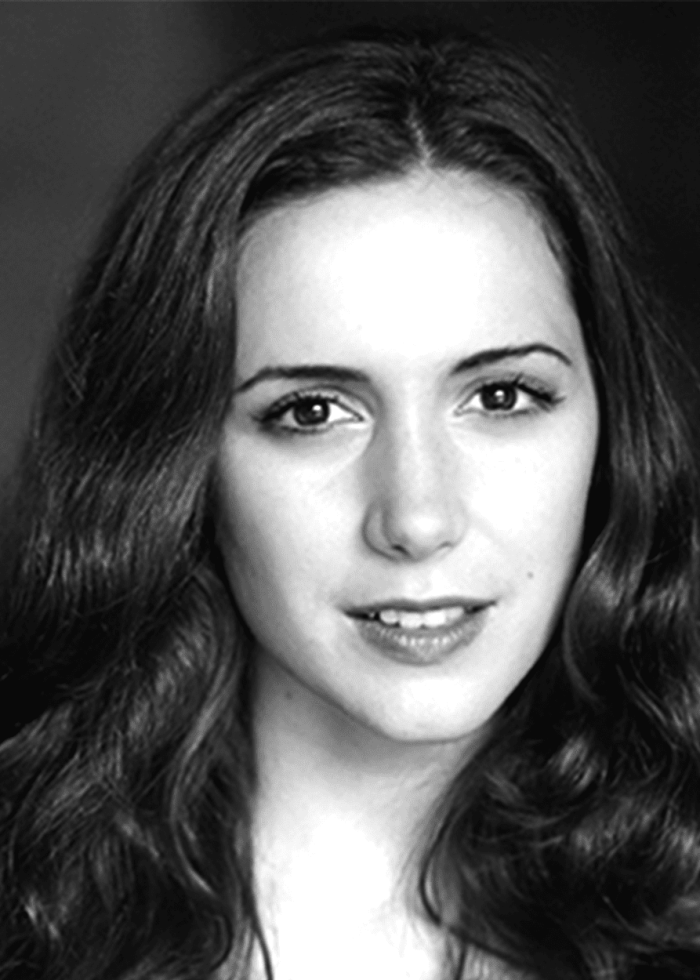 Talene Monahon, actress, looking at the camera with a slight smile.