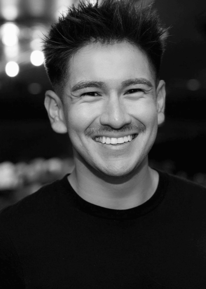 Smiling man with mustache in black and white portrait