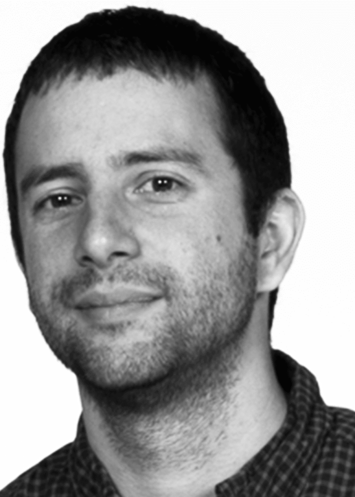 Portrait of Itamar Moses, a man with short dark hair and a beard