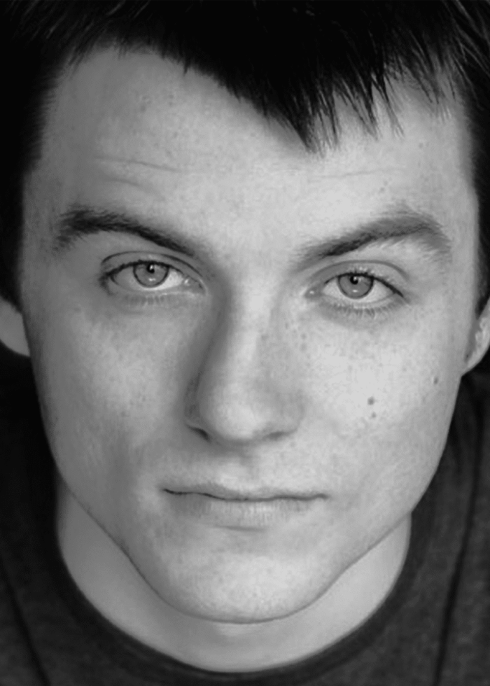 Patrick Murney, a man with a direct gaze, black and white portrait.