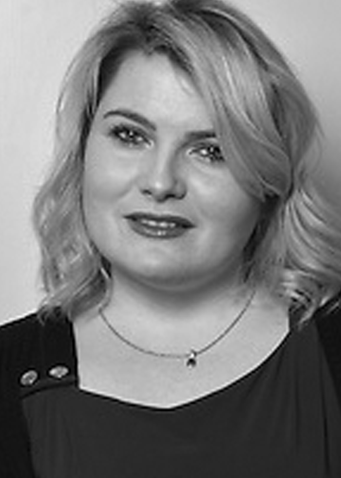 Portrait of Nancy Harris with blonde hair, wearing a necklace