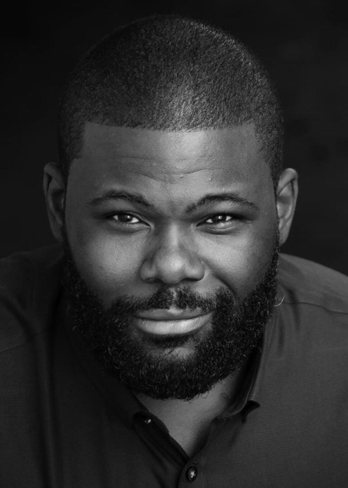 Neil Tyrone Pritchard, black and white headshot, smiling with a full beard.
