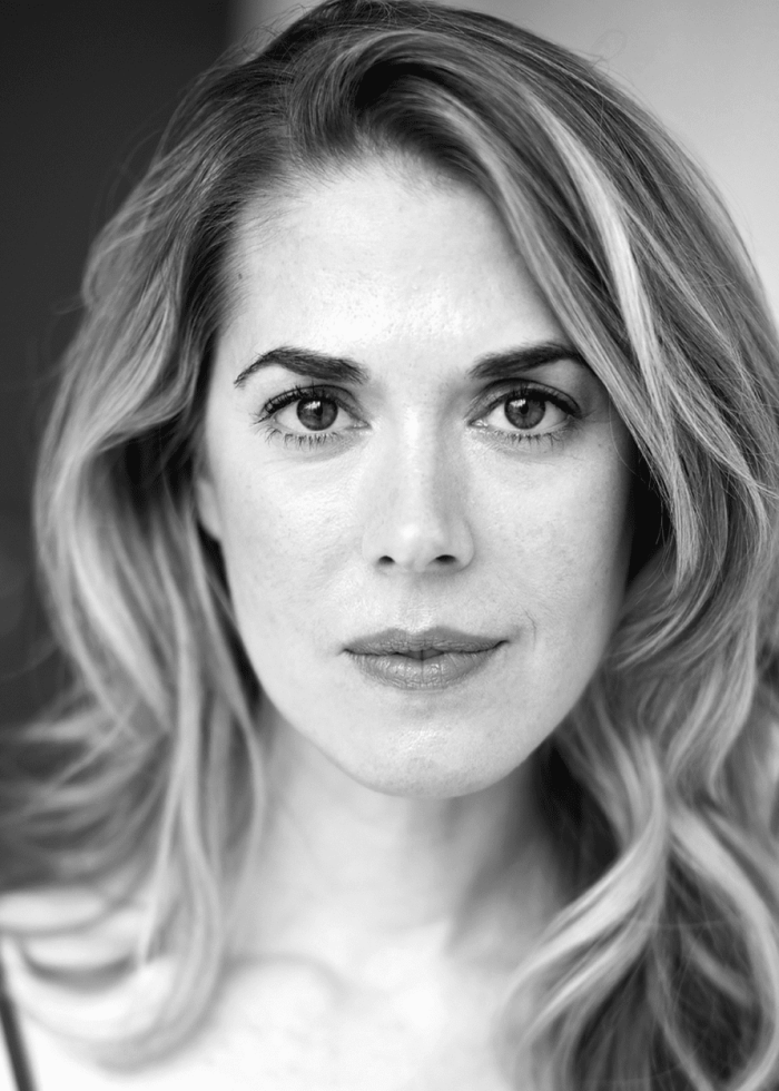 Lucy Owen looking directly at the camera, black and white portrait.