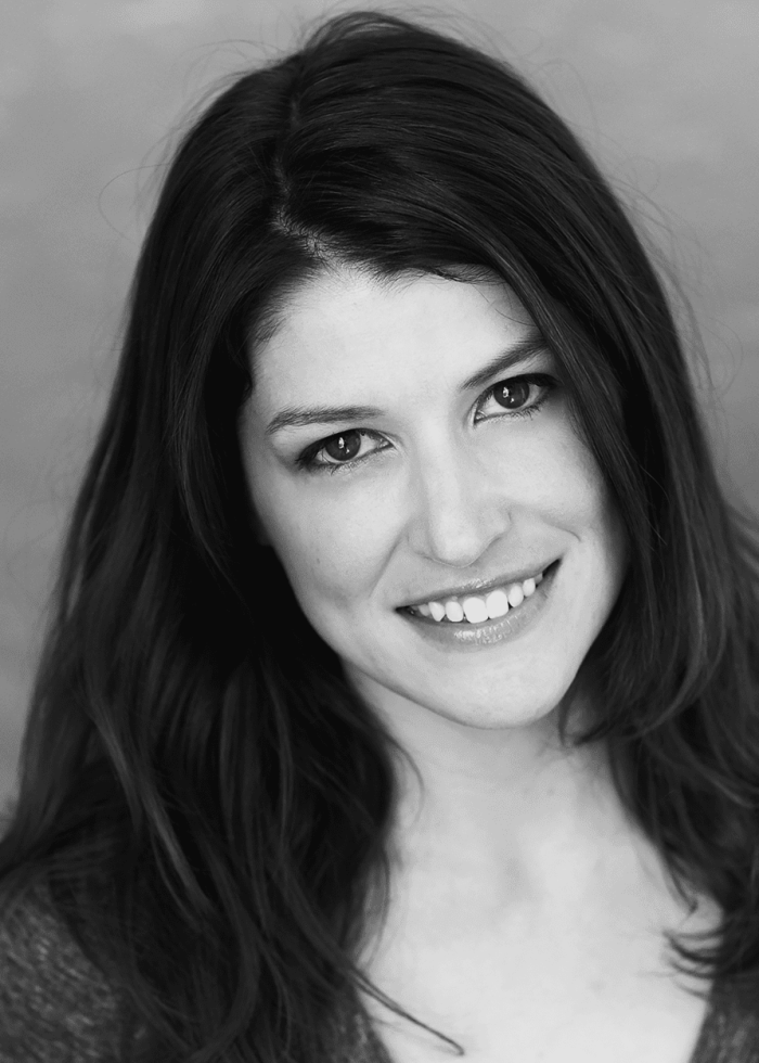 Smiling woman with long dark hair, looking at the camera