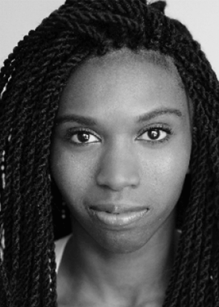Rachel Pegram portrait with dark braids, looking directly at the camera.