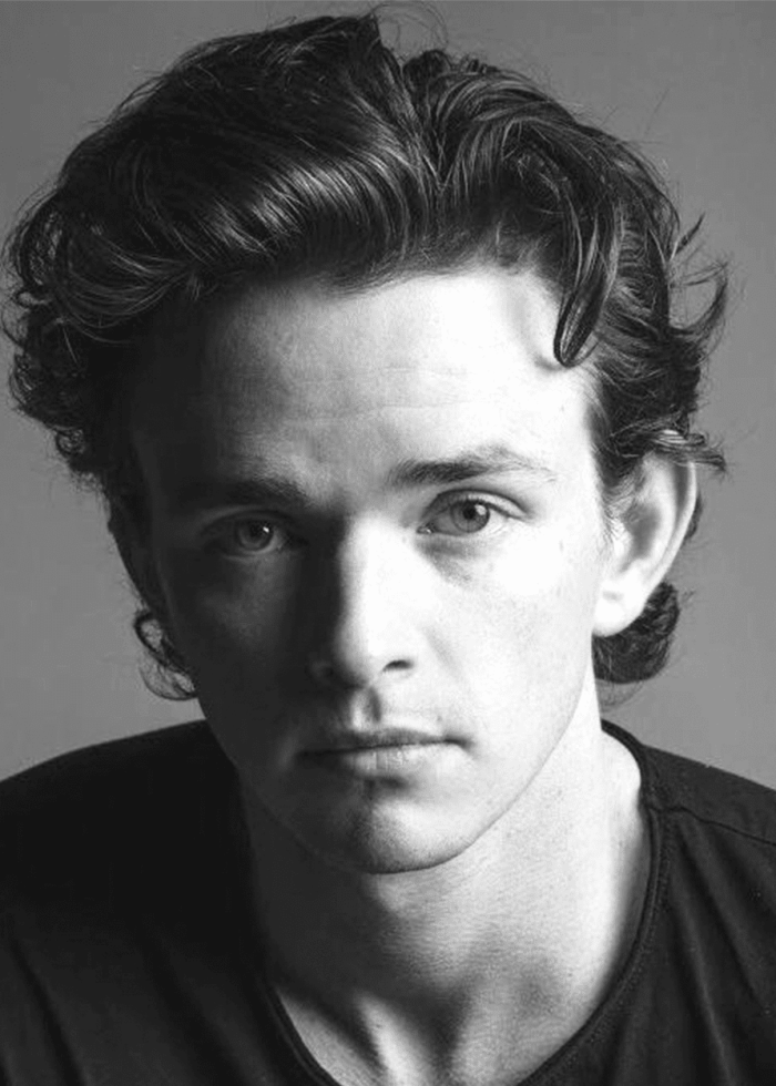 Peter Laprade looking directly at the camera in black and white.