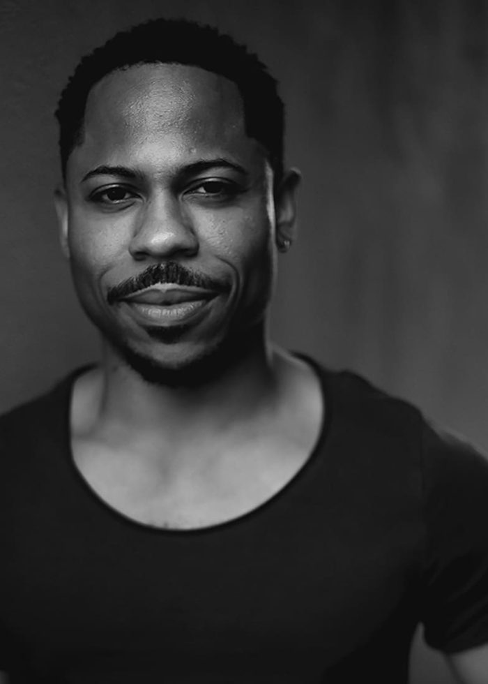 Ro Boddie smiling, headshot in black and white