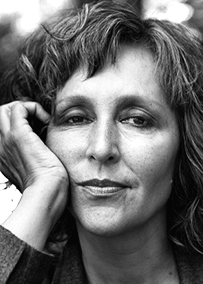 Close-up portrait of Lisa Ramirez with hand on cheek, looking thoughtful