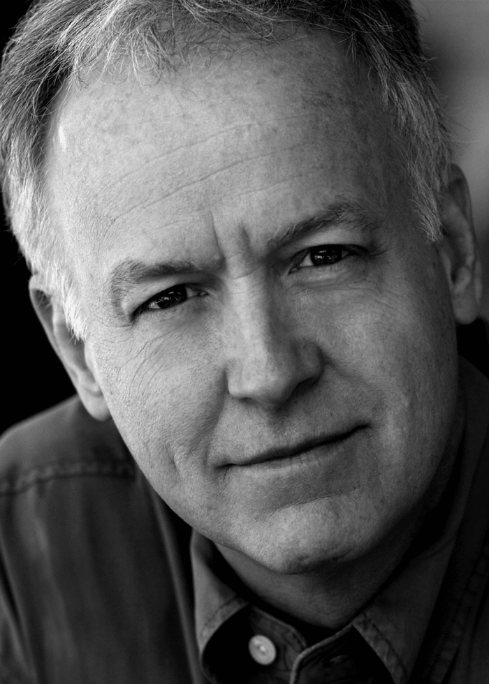 Close-up portrait of actor Reed Birney, looking directly at the camera.